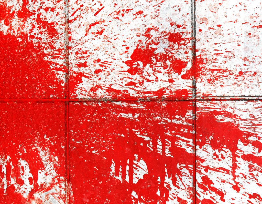 Red paint splatter on white tiles