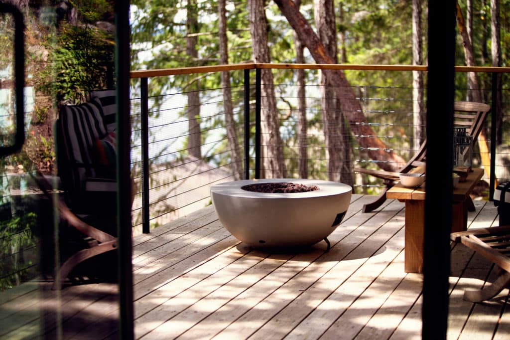 Gas fire pit on a wood deck.