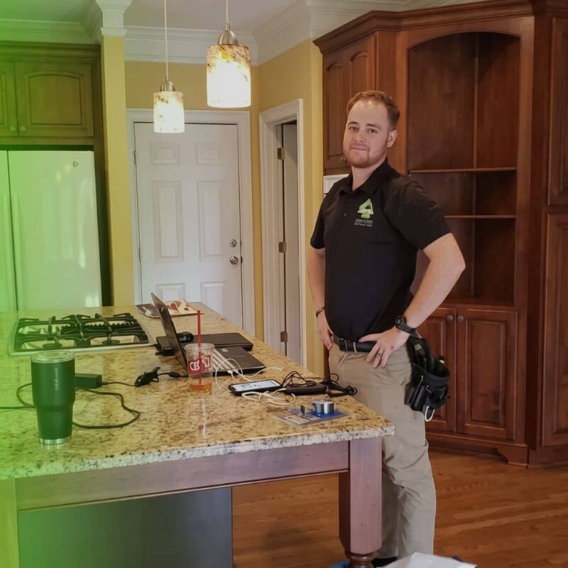 Avalon Home inspector standing next to radon test device placed on kitchen counter during a home inspection in Atlanta GA