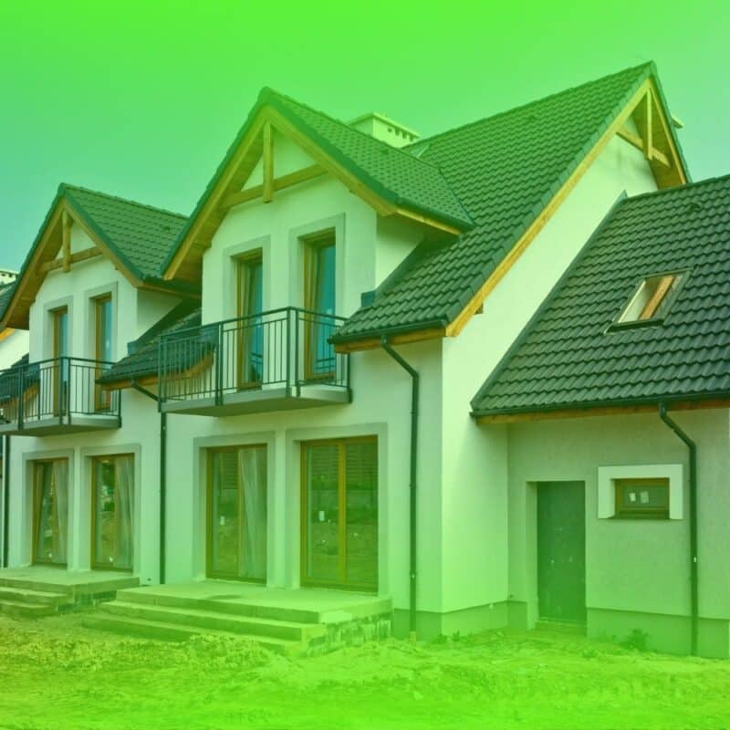 Newly constructed modern multi-story homes with dark tile roofs eligible for a builder warranty inspection