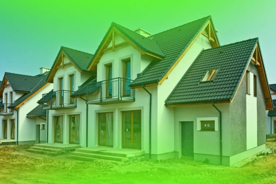Newly constructed modern multi-story homes with dark tile roofs eligible for a builder warranty inspection